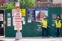 Construction workers help direct traffic outside a residential and commercial building under construction at the Essex Crossing development on the Lower East Side of Manhattan, Thursday, Aug. 4, 2022. America’s hiring boom continued last month as employers added a surprising 528,000 jobs despite raging inflation and rising anxiety about a recession.