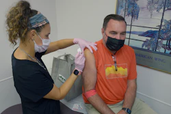 Robert Terwilliger, right, of Williamsburg, Pa., who is participating in a Lyme disease vaccine trial at the Altoona Center for Clinical Research, is injected with either the new vaccine or a placebo, by registered nurse Janae Roland, Friday, Aug. 5, 2022, in Duncansville, Pa. Lyme is a growing problem, with cases steadily rising and warming weather helping ticks expand their habitat.