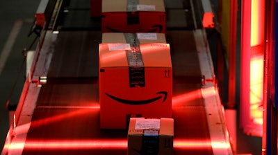 Packages riding on a belt are scanned to be loaded onto delivery trucks at the Amazon Fulfillment center in Robbinsville Township, N.J., on Aug. 1, 2017.