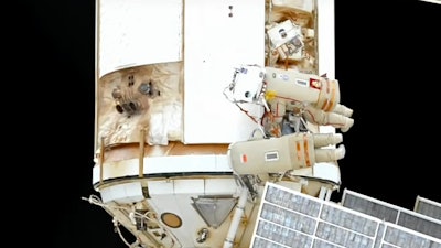 In this photo taken from video footage released by Roscosmos Space Agency, Roscosmos' cosmonauts Oleg Artemyev and Denis Matveev are seen during their spacewalk on the International Space Station (ISS), Wednesday, Aug. 17, 2022.