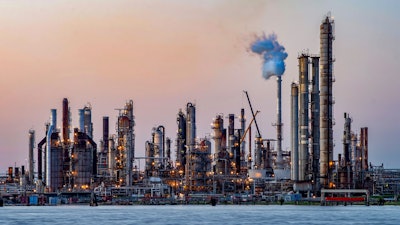 The sun sets at Chalmette refinery in Chalmette, La., located just over the Mississippi River levee May 3, 2020. While the Inflation Reduction Act concentrates on clean energy incentives that could drastically reduce overall U.S. emissions, it also buoys oil and gas interests by mandating leasing of vast areas of public lands and off the nation’s coasts.