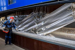 A worker moves hot-dip galvanized metal pieces at Zinkpower, Meckenheim, Germany, Aug. 18, 2022.