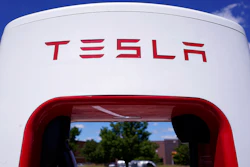 Tesla Supercharger is seen at Willow Festival shopping plaza parking lot Wednesday, Aug. 10, 2022, in Northbrook, Ill. Tesla is splitting its stock 3 for 1, so after the close of trading Tuesday, Aug. 23, investors will receive two additional Tesla shares for every one they owned as of Aug. 17. In theory, that should drop Tesla’s share price by about two-thirds before trading starts on Wednesday.