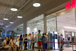 People line up to enter an H&M shop and buy items on sale in the Aviapark shopping mall in Moscow, Russia, Tuesday, Aug. 9, 2022. Russians are snapping up Western fashion and furniture this week as H&M and IKEA sell off the last of their inventory in Russia, moving forward with their exit from the country after it sent troops into Ukraine. Sweden-based H&M and Netherlands-based IKEA had paused sales in Russia after the military operation began and are now looking to unload their stocks of clothing and furnishings as they wind down operations there.