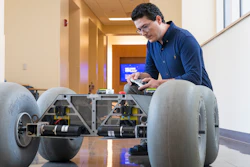 Cagri Kilic, postdoctoral research fellow in the WVU Statler College of Engineering and Mineral Resources, shows off a rover that he developed to research slips in planetary rovers. Two other researchers are applying this same technology to improve safety in retail and wholesale settings.