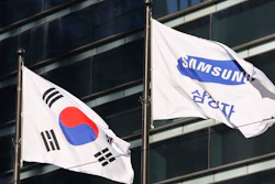 The company flag of Samsung Electronics, right, flutters next to the South Korean national flag in Seoul, South Korea, on Jan. 16, 2017.