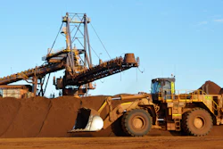 Earth moving equipment work at the site of Fortescue Metals Group's Christmas Creek iron ore operations in the Pilbara region of Western Australia, June 17, 2014.
