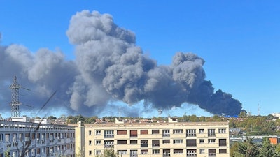 Smoke rises from a warehouse blaze at a produce market in Paris' southern suburbs, Sept. 25, 2022.