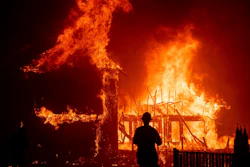 A home burns as the Camp Fire rages through Paradise, Calif., Nov. 8, 2018.