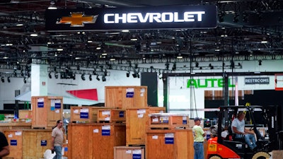 Workers set up for the North American International Auto Show in Detroit, Wednesday, Sept. 7, 2022. The show will be smaller with few new model debuts, less-glitzy displays, fewer journalists and lower attendance that past years.