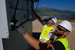Maintenance engineers check installations at a new solar park outside the northern Greek city of Kozani on June 3, 2022. A new report has found that clean energy now provides more employment than the fossil fuel industry, reflecting the shift that efforts to tackle climate change are having on the global jobs market.