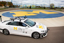 An open-source connected and automated research vehicle is parked on the roundabout at the Mcity Test Facility, the world’s first purpose-built proving ground for testing the performance and safety of connected and automated vehicles and technologies under controlled and realistic conditions.