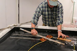 Co owner of Building Resilient Solutions, Kerry Shackelford hooks up pine boards that are used to test flood resistance at his lab Tuesday, Oct. 4, 2022, in Suffolk , Va.