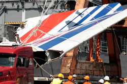 Workers unload debris, belonging to the crashed Air France flight AF447, from the Brazilian Navy's Constitution Frigate in the port of Recife, northeast of Brazil, June 14, 2009.