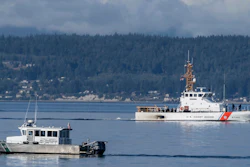 A U.S. Coast Guard boat and Kitsap, Wash., County Sheriff's Office boat search the area near Freeland, Wash., on Whidbey Island north of Seattle, Monday, Sept. 5, 2022, where a chartered floatplane crashed the day before, killing 10 people.