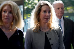 Former Theranos CEO Elizabeth Holmes, center, her mother, Noel Holmes, left, and father, Christian Holmes IV, arrive at federal court in San Jose, Calif., on Sept. 1, 2022.