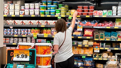 A customer looks at refrigerated items at a Grocery Outlet store in Pleasanton, Calif.,. on Thursday, Sept. 15, 2022. 'Best before” labels are coming under scrutiny as concerns about food waste grow around the world. Manufacturers have used the labels for decades to estimate peak freshness. But “best before” labels have nothing to do with safety, and some worry they encourage consumers to throw away food that’s perfectly fine to eat.