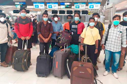 In this photo provided by the Ministry of External Affairs, Indian workers rescued after they were lured by agents for fake job opportunities in the information technology sector in Thailand arrive at the airport in Chennai, India, Wednesday, Oct. 5, 2022. Arindam Bagchi, the External Affairs Ministry spokesperson, said some fraudulent IT companies appear to be engaged in digital scamming and forged cryptocurrencies. The Indian workers were held captive and forced to commit cyber fraud, he told reporters.