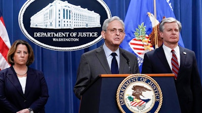 Attorney General Merrick Garland, joined by otters Justice officials, speaks to reporters as they announce charges against two men suspected of being Chinese intelligence officers for attempting to obstruct a U.S. criminal investigation and prosecution of Chinese tech giant Huawei, at the Department of Justice in Washington, Monday, Oct. 23, 2022.