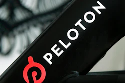 This Nov. 19, 2019 photo shows a Peloton logo on the company's stationary bicycle in San Francisco, Calif. Peloton told employees Thursday, Oct. 6, 2022, that it will cut approximately 500 jobs, or about 12% of its workforce, as post- pandemic sales of its indoor exercise equipment continues to tail off.