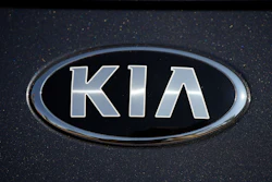 The company logo shines off the hood of a 2021 K5 sedan on display in the Kia exhibit at the Denver auto show Friday, Sept. 17, 2021, at Elitch's Gardens in downtown Denver.