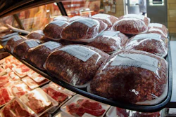 In this photo made on Thursday, June 16, 2022, rows of fresh meat is seen through the display coolers as a woman enters the retail section at the Wight's Meat Packing facility in Fombell, Pa.