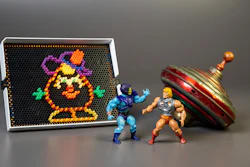 This undated photo provided by The Strong Museum shows the three toys inducted into the National Toy Hall of Fame on Nov. 10, 2022, in Rochester, N.Y. Masters of the Universe, Lite-Brite and the top were chosen from among 12 finalists for the annual honor, which recognizes toys that have inspired creative play and lasting popularity.