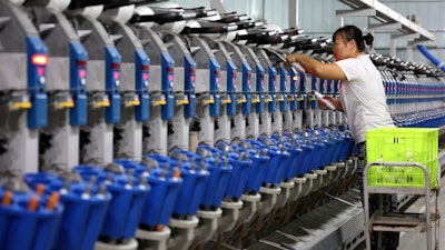 A woman works in a textile factory in Human in eastern China's Shandong Province, Nov. 1, 2022.