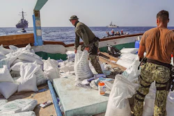 In this photo released by the U.S. Navy, sailors inventory urea and ammonium perchlorate found on a dhow intercepted in the Gulf of Oman on Nov. 9, 2022.