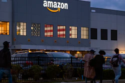 People arrive for work at an Amazon distribution center in Staten Island, New York, Oct. 25, 2021.