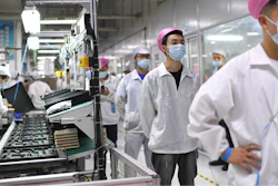 Workers line up to get tested for COVID-19 at the Foxconn factory in Wuhan in central China's Hubei province on Aug. 5, 2021.