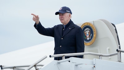 President Joe Biden gestures boarding Air Force One at Nantucket Memorial Airport in Nantucket, Mass., Sunday, Nov. 27, 2022.