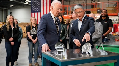 President Joe Biden tours SK Siltron CSS, a computer chip factory in Bay City, Mich., Tuesday, Nov. 29, 2022, with SK Siltron CSS CEO Jianwei Dong.