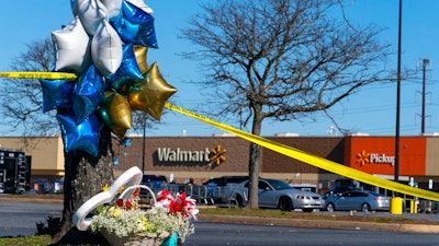 Flowers and balloons have been placed near the scene of a mass shooting at a Walmart, Wednesday, Nov. 23, 2022, in Chesapeake, Va. A Walmart manager opened fire on fellow employees in the break room of the Virginia store, killing several people in the country’s second high-profile mass shooting in four days, police and witnesses said Wednesday.
