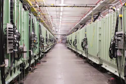 The green-colored chambers use electromagnetic waves to accelerate charged ions to nearly half the speed of light.