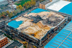 In this aerial photo, a building at the center of a deadly fire is seen in Anyang in central China's Henan Province, Tuesday, Nov. 22, 2022. Investigators said that sparks from welding work appears to have been the cause of a fire that killed several dozen people at a company dealing in chemicals and other industrial goods in central China's Henan province.