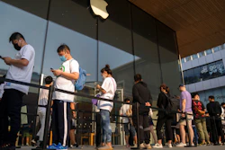 Customers line up outside of an Apple Store before its opening on the first day of sale for the Apple iPhone 14 in Beijing, China on Sept. 16, 2022. Apple Inc. is warning customers will have to wait longer to get its latest iPhone models after anti-virus restrictions were imposed on a contractor's factory in central China.