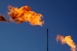 Flares burn off methane and other hydrocarbons at an oil and gas facility in Lenorah, Texas, Oct. 15, 2021.