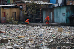 City workers remove garbage floating on the Negro River, Manaus, Brazil, June 6, 2022.
