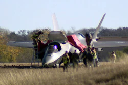 This image taken from video provided by KDFW, shows emergency personnel at the scene after a fighter jet crash landed at Naval Air Station Joint Reserve Base in Fort Worth, Texas, Thursday, Dec. 15, 2022.