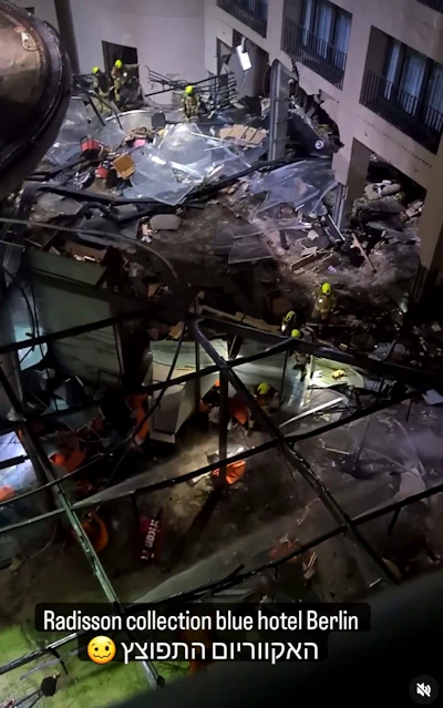 Following the burst of a huge aquarium, the atrium of a hotel is devastated in Berlin Germany, Friday, Dec. 16, 2022. German police say a huge aquarium in the center of Berlin has burst, causing a wave of devastation in and around the Sea Life tourist attraction. The words in Hebrew reads: 'The Aquarium exploded'.