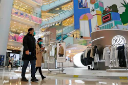 Shoppers walk through a reopened shopping mall after authorities started easing some of the anti-virus controls in Beijing on Dec. 6, 2022.