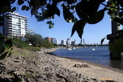 A section of newly formed beach is shown on the Willamette River in downtown Portland, Ore., on July 6, 2017. Monsanto has agreed to pay Oregon a lump sum of $698 million for its role in polluting the state with PCBs over a 90-year period until they were banned in 1977. Oregon Attorney General Ellen Rosenblum said Thursday, Dec. 15, 2022, that the settlement amount is the largest environmental damage recovery in Oregon's history.