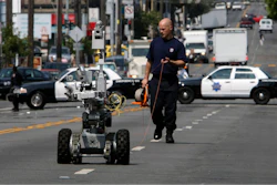 A police officer uses a robot to investigate a bomb threat in San Francisco, on July 25, 2008.
