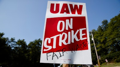 A sign is posted during a demonstration outside a General Motors facility in Langhorne, Pa., on Sept. 23, 2019.