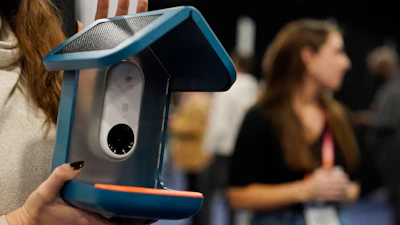 An exhibitor holds up the Bird Buddy smart camera bird feeder during CES Unveiled before the start of the CES tech show, Tuesday, Jan. 3, 2023, in Las Vegas. The AI-powered camera bird feeder notifies you when a bird is feeding, takes pictures and organizes the photos.