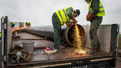 Employees work at the site of the damaged pipeline near Valakeliai village, outside Pasvalys, 175 km (109 miles) north of Vilnius in northern Lithuania on Saturday Jan. 14, 2023.