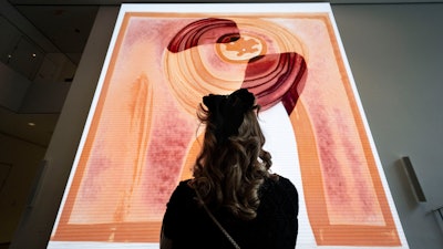 A visitor looks at artist Refik Anadol's 'Unsupervised' exhibit at the Museum of Modern Art, Wednesday, Jan. 11, 2023, in New York.