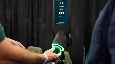An exhibitor demonstrates the OneThird avocado ripeness checker during CES Unveiled, Jan. 3, 2023, Las Vegas.