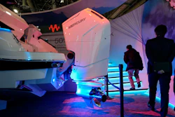 People walk by a Mercury V12 600 HP gas boat motor at the Brunswick booth during the CES tech show Friday, Jan. 6, 2023, in Las Vegas.